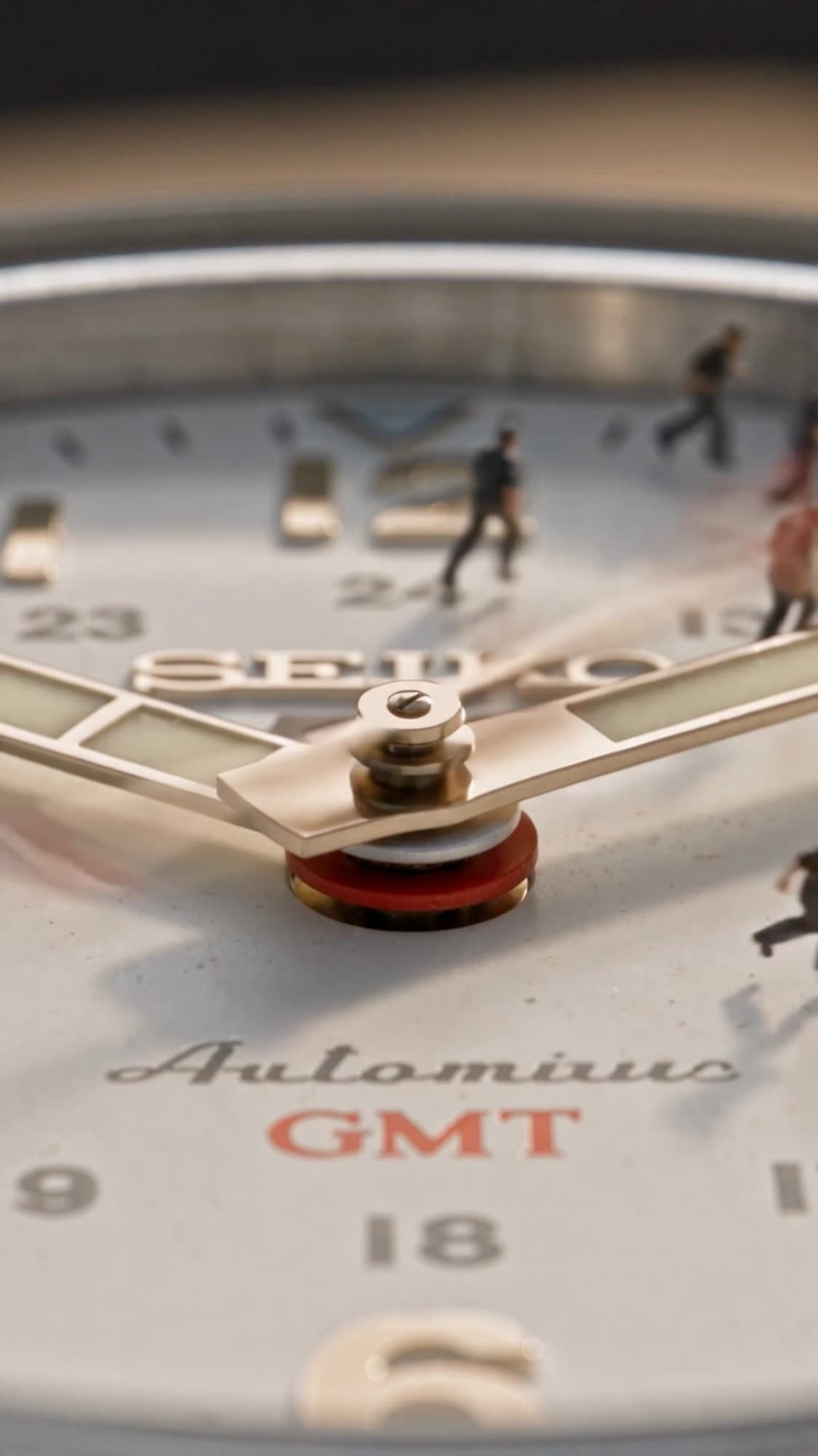 The whole dial working at once — crews running between markers as the hands sweep overhead