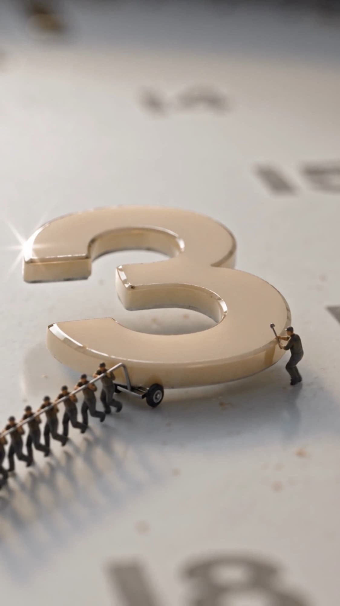 A line of miniature workers hauling a handcart up to a raised cream numeral