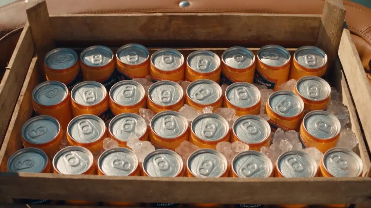 Crate of cans on ice, delivered through a lemon grove archway
